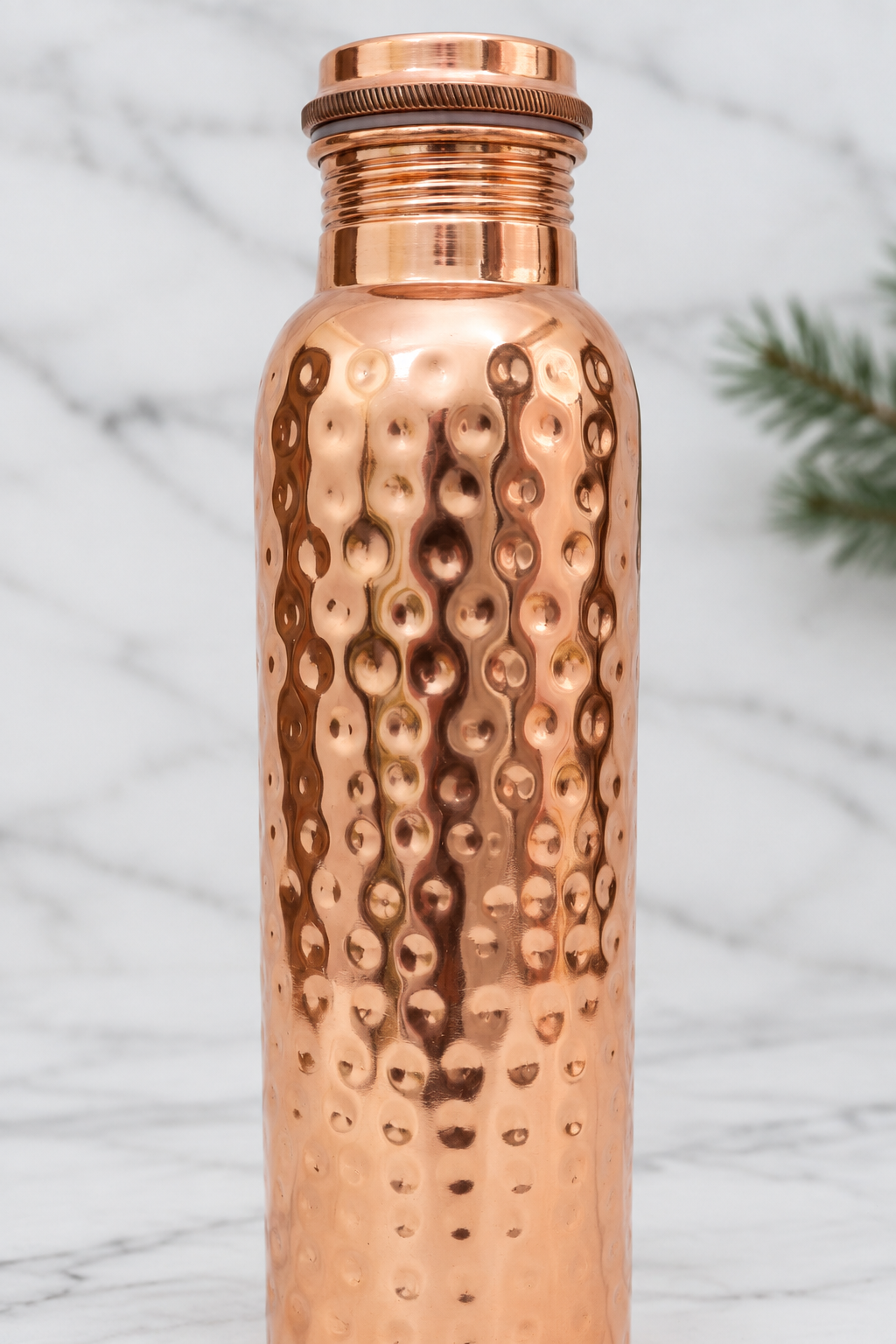 Close-up detail of the hammered copper bottle and screw-in lid