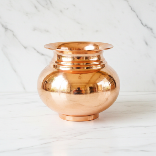 Copper lota front view on white marble