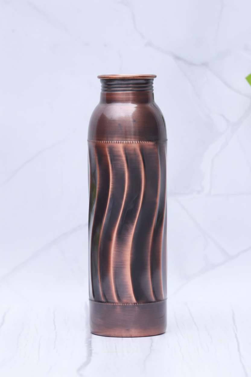 Antique swirl copper bottle 3/4 angle on white marble