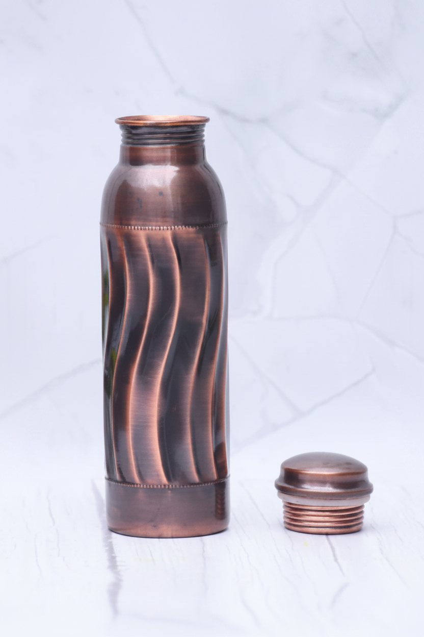 Antique swirl copper bottle cap off on white marble