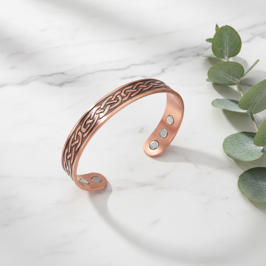 Copper water ripple bracelet flat lay with eucalyptus