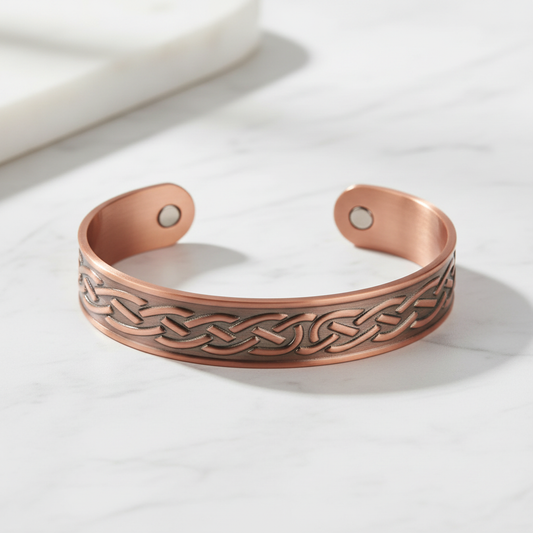 Copper water ripple bracelet flat on white marble
